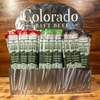 Display of Colorado Craft Beef packages on a wooden surface with a wooden background.